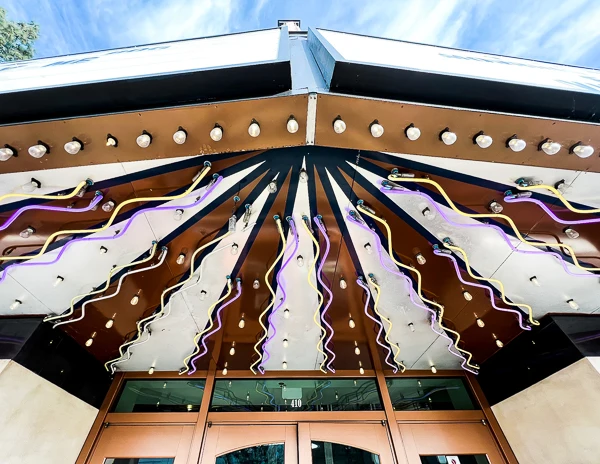 Close-up of the retro-style awning with zig-zag neon lights and lightbulbs at Look Dine-In Cinemas in Monrovia.