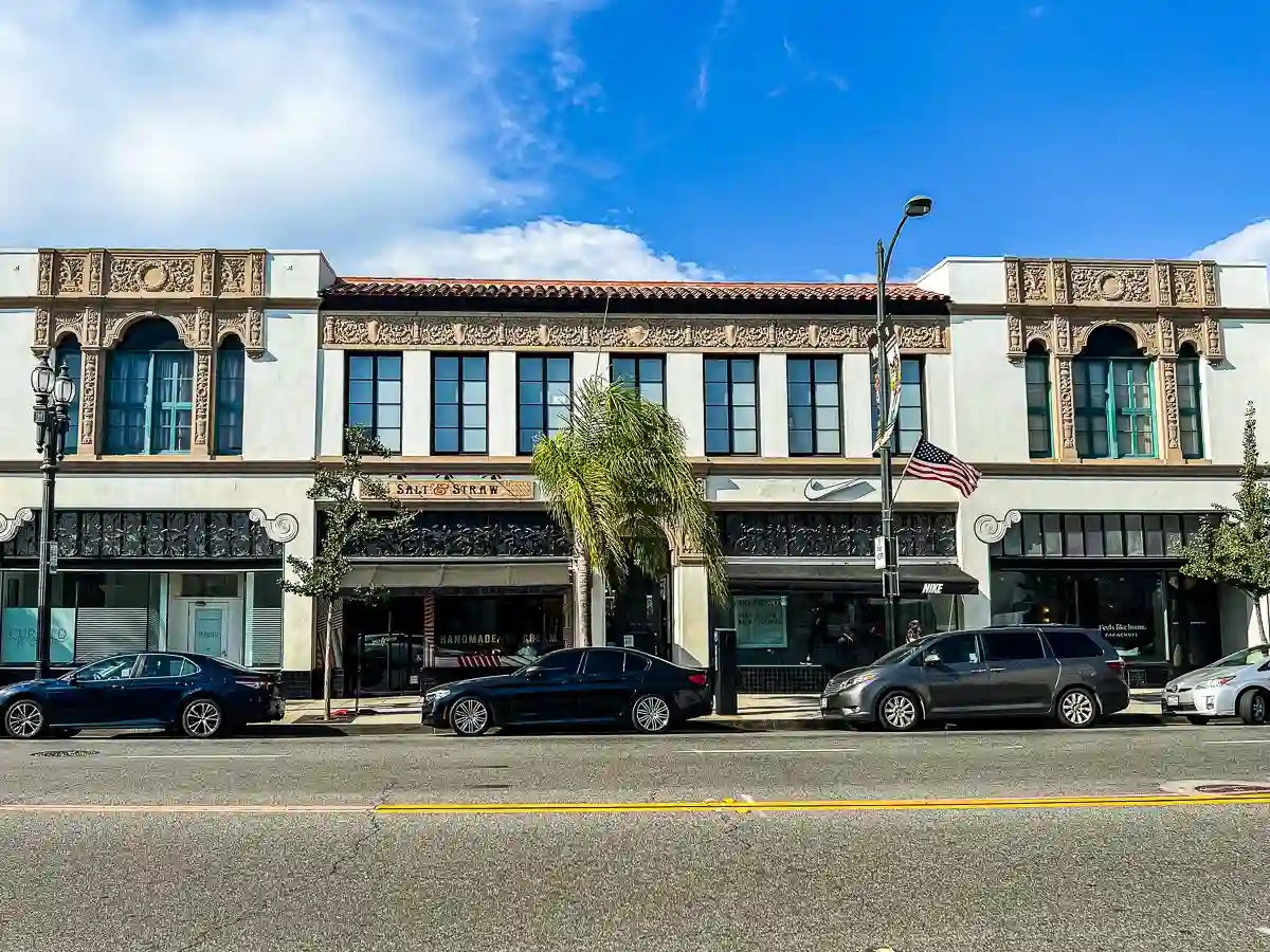 Old Pasadena street scene with various shops along Colorado Boulevard, showcasing a mix of retail and vibrant storefronts.