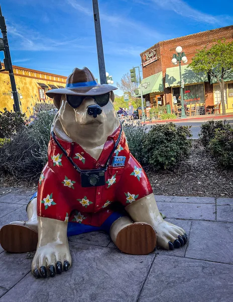 statue of polar bear ready for vacation with red hawaiian shirt and sunglasses