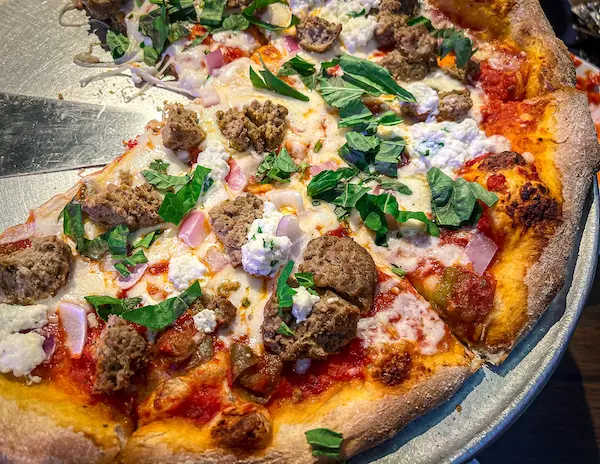 pizza with tomato sauce, cheese, meatballs and basil