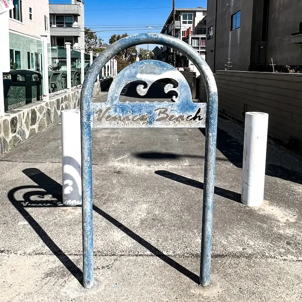 venice beach art etched into a metal pole along the boardwalk