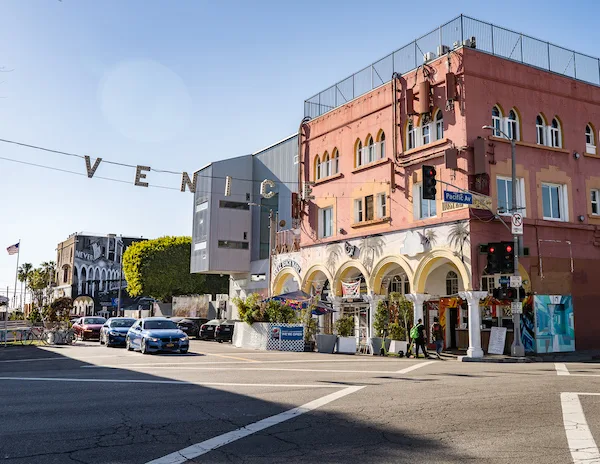 letters hanging across a street spelling out venice