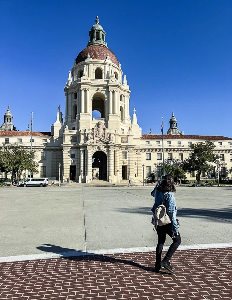 A person walking toward Pasadena City Hall, with the grand building and its impressive dome clearly visible in the background.