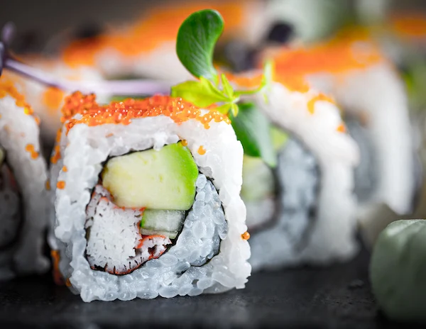 sushi roll filled with avocado, crab and cucumner