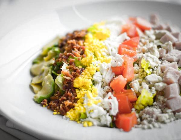 a plate of salad toppings to make a cobb salad