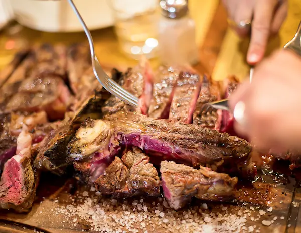 cutting into bistecca alla fiorentina