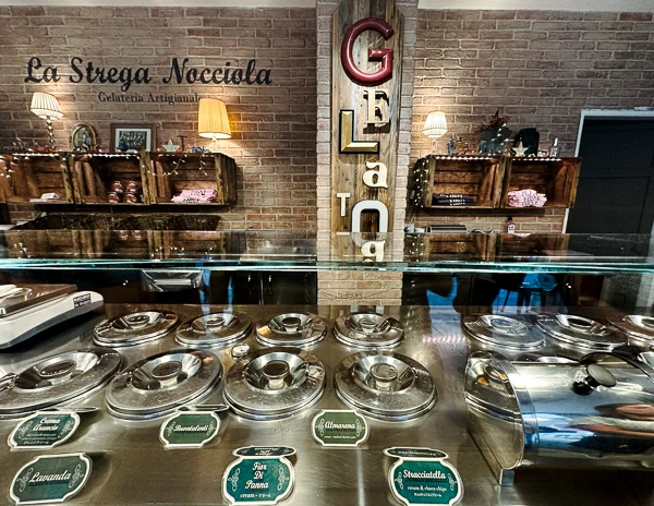 artisal gelateria in florence italy with gelato covered with metal tins