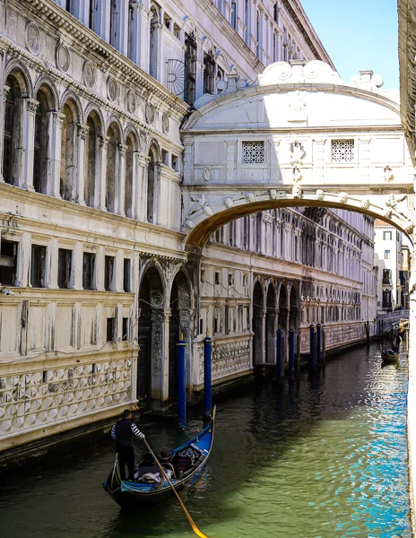gondola about to pass under the bridge of sighs in venice italy