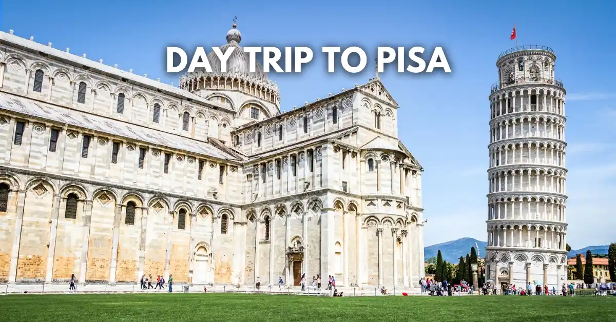 featured blog image: Day Trip to Pisa text overlay on a wide photo of the Leaning Tower of Pisa and Pisa Cathedral in Piazza dei Miracoli with visitors walking through the square on a clear day