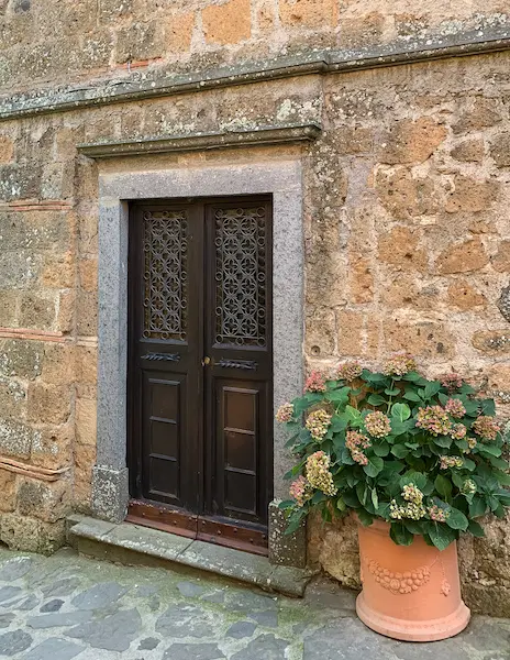a wooden door surrounded by a stone facade