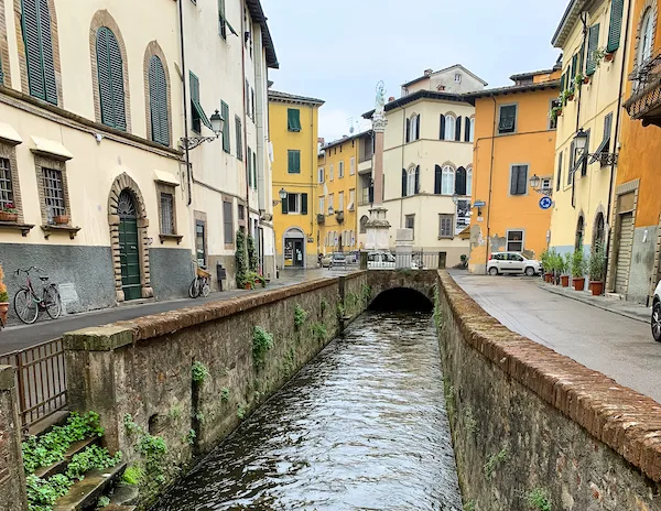small canal among italian renaissance buildings in lucca