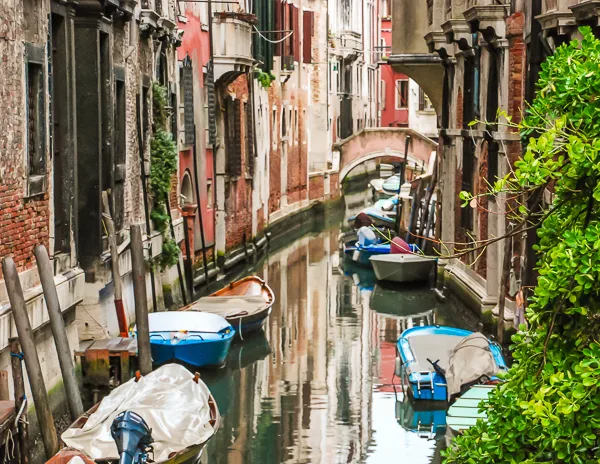 a canal in venice italy with boats