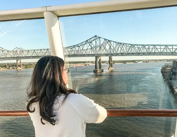 woman looking out at Crescent City Connection bridge