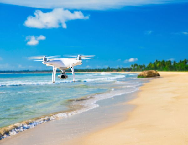 drone flying over a beach shore