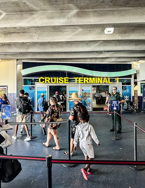 Passengers lined up outside Cruise Terminal 1 on embarkation day, waiting to go through security before boarding their ship.
