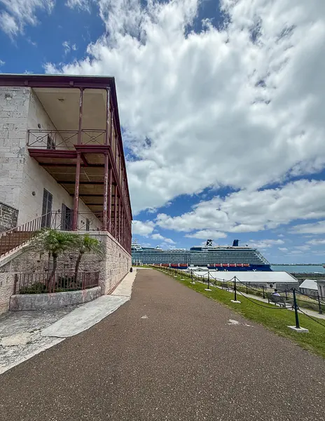 Pathway outside the National Museum of Bermuda at Royal Naval Dockyard with a cruise ship docked in the background.