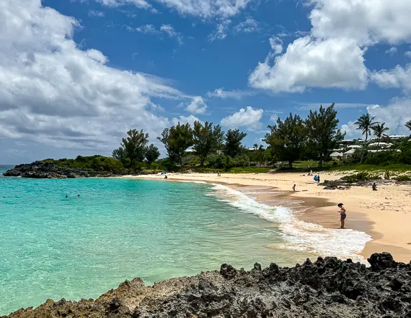 John Smith’s Bay beach in Bermuda with turquoise water, rocky shoreline, and a quiet sandy cove.