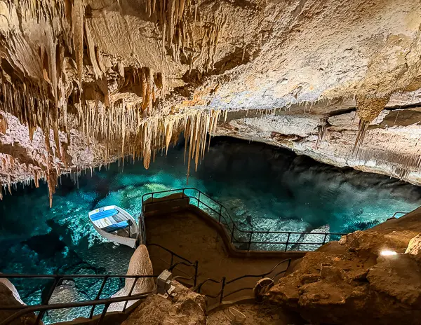 Fantasy Cave in Bermuda with limestone formations, stairs, and clear blue underground water.