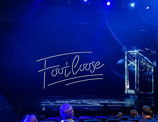 The word footloose glowing on the stage