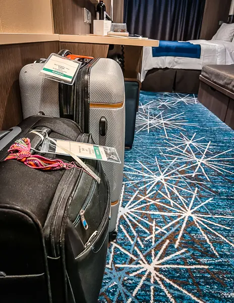 luggage sitting inside cruise cabin