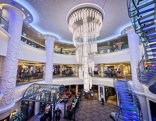 Cruise ship atrium with multiple decks and public seating areas onboard