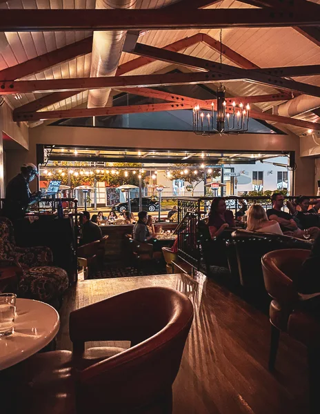 view inside restaurant of diners eating looking out into the open front patio