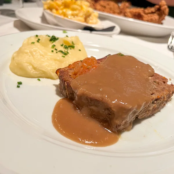 meatloaf covered in gravy with mash potatoes
