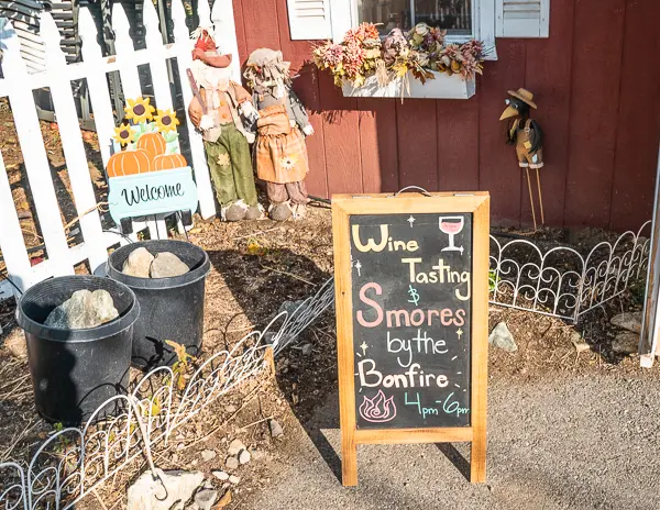 Signboard at Willowbrook Apple Farm advertising wine tasting and s'mores by the bonfire.
