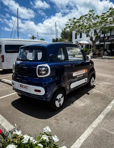 Small electric rental vehicle parked in Bermuda, one of the transportation options visitors can use to get around the island.