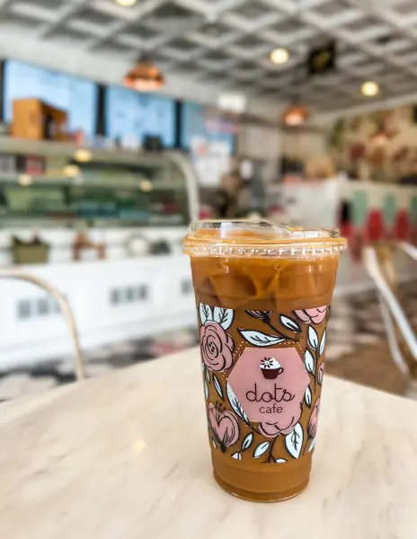 iced latte with dots cafe logo and branding