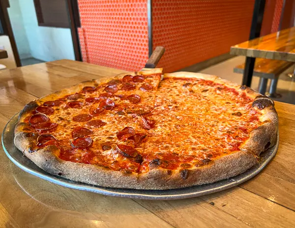 large new york style pizza with half pepperoni from tomato pie pizza joint