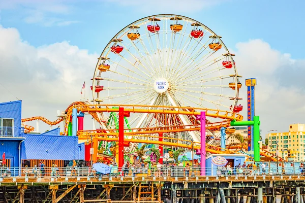 colorful ferris wheel and coaster at pacific park in santa monica
