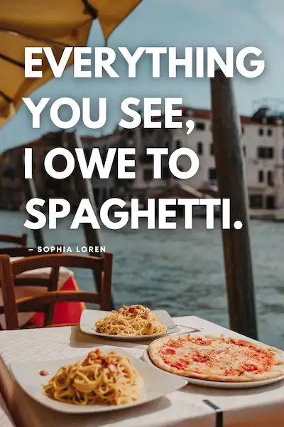 Plates of spaghetti and a cheese pizza on an outdoor café table overlooking a canal, with wooden chairs and yellow umbrellas in the background. The text on the image reads: “Everything you see, I owe to spaghetti. — Sophia Loren.”