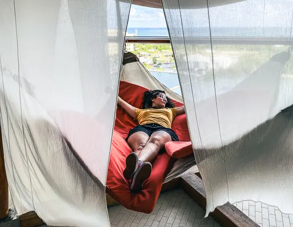 kathy lying back on a hammock on a cruise