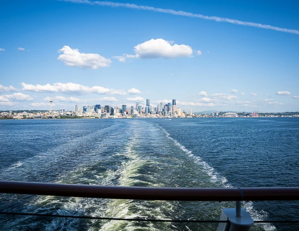 seattle skyline at sail away from cruise ship aft