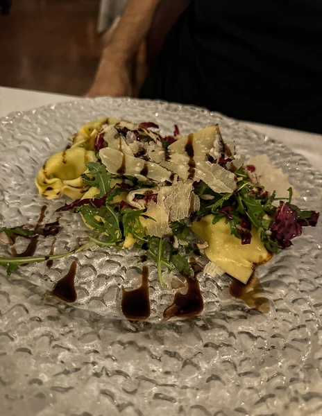 tortellini with parmesan cheese, fried pancetta and greens with balsamic vinegar