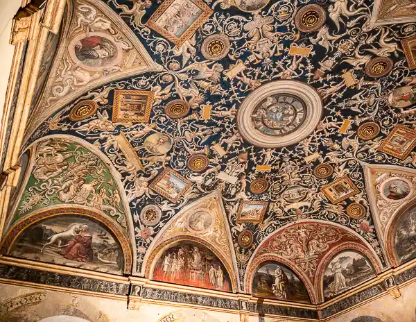 Detailed view of Correggio’s frescoed ceiling inside the Chamber of St. Paul in Parma, Italy, featuring mythological figures and intricate decoration