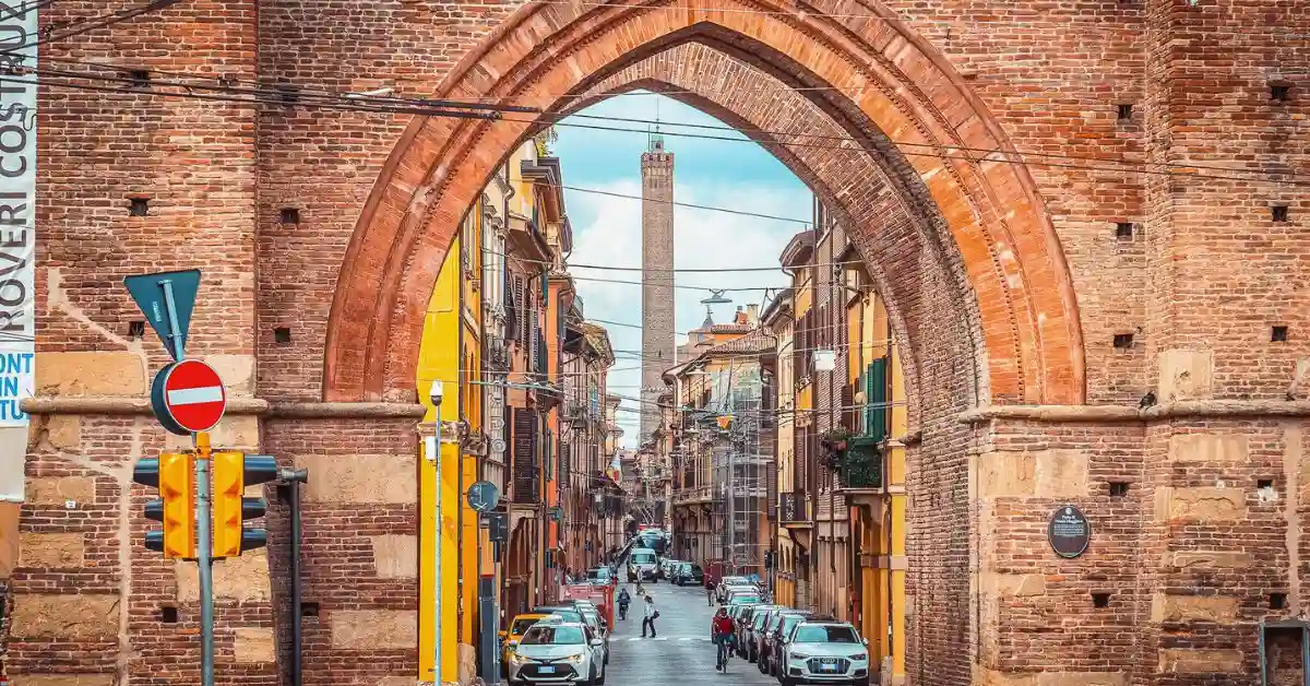 featured image: View through Porta San Vitale in Bologna, Italy, with Torre Asinelli in the distance—perfect starting point for day trips from Bologna.