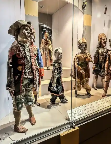 Display of historical character puppets dressed in detailed costumes at the Giordano Ferrari Museum in Parma