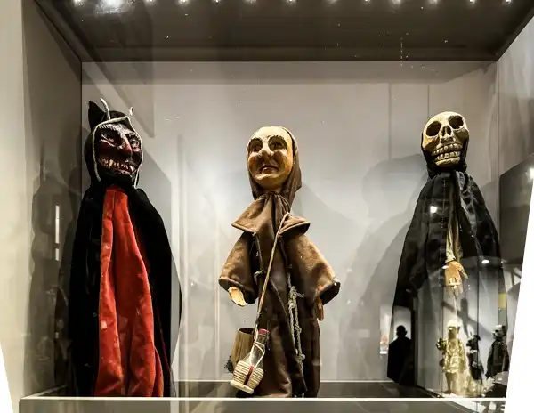 Three traditional marionette puppets on display at the Giordano Ferrari Museum in Parma, Italy