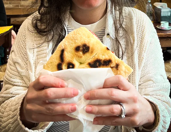 holding a panino from pinos sandwiches in florence italy