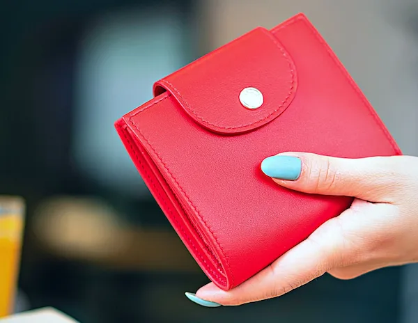 hand holding a red wallet