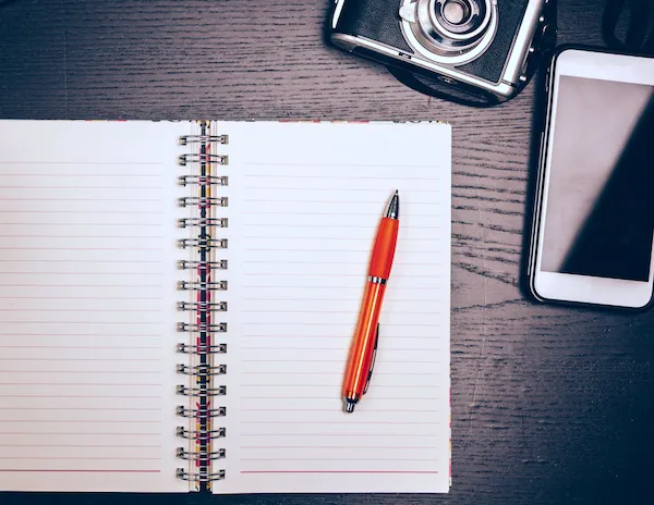 red pen sitting on notebook