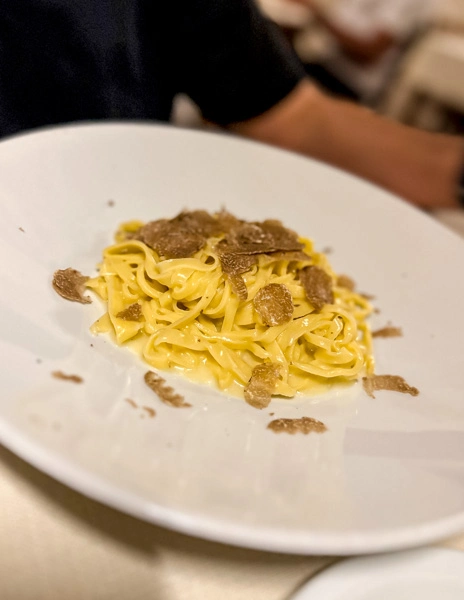 shaved white truffle over tagliolini pasta at osteria del leone
