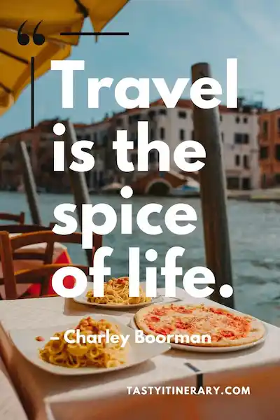 Food and travel quote graphic reading “Travel is the spice of life” by Charley Boorman, over a waterfront restaurant scene with pizza and pasta on a table.