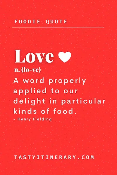 Food quote graphic featuring Henry Fielding’s definition of love, “A word properly applied to our delight in particular kinds of food,” in white text on a red background with a white heart icon.