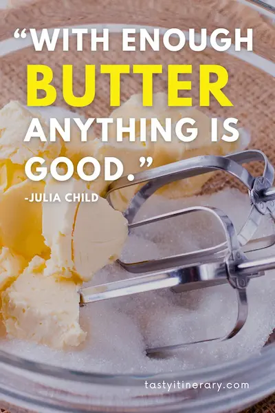 Food quote graphic featuring “With enough butter, anything is good” by Julia Child, over a close-up photo of butter and metal mixer beaters in a mixing bowl.