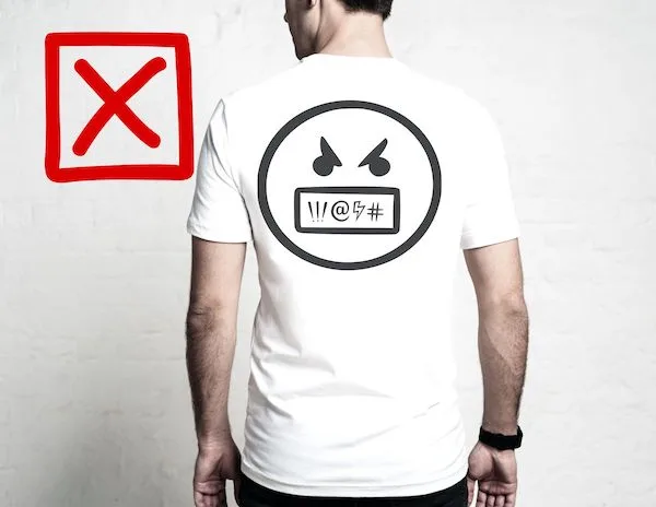 graphic of a male facing forward with a mad symbol and a red x on the t-shirt to demonstrate no offensive language or graphics on clothing 