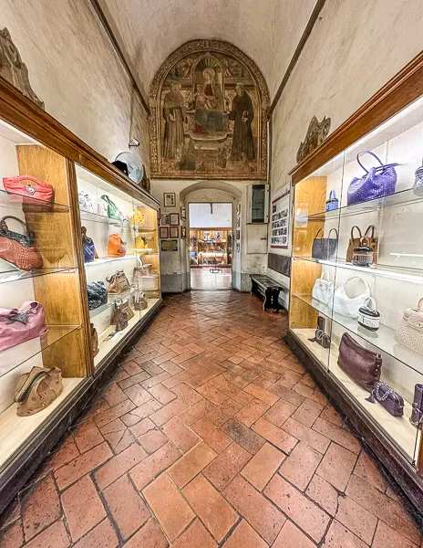 corridor of purses in cases at the leather school of florence