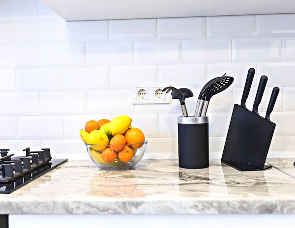 kitchen counter with fruits and cooking utensils